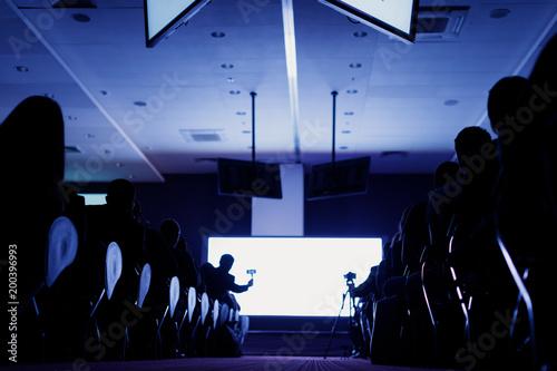 Business Conference and Presentation. Audience at the conference hall. Rear view of Audience in the conference hall or seminar meeting