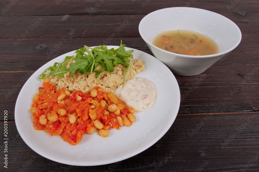 Baked beans and carrot with couscous on a table