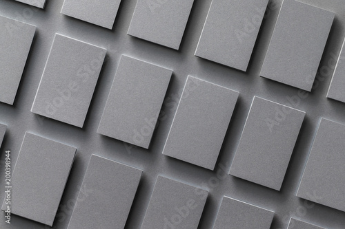 Mockup of black empty business cards stacks arranged in rows at textured background. Brand identity. © Mayatnikstudio