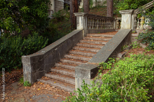 beautiful original staircase made of stone in a green summer park