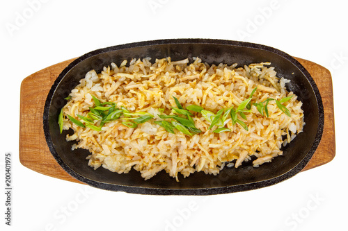 chahan with chicken, pork, with meat, green onions serving on a hot frying pan, on a wooden board on white isolated background view from above. For the menu, restaurant, bar, cafe