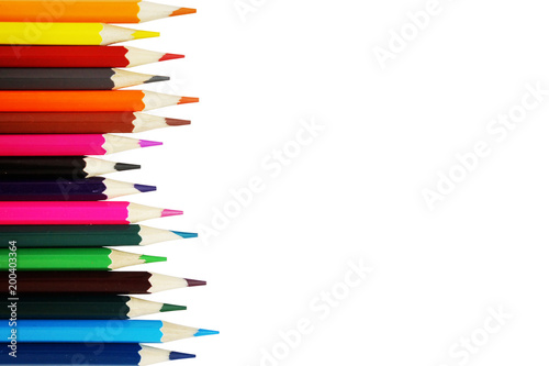 Color pencils isolated on white background. Empty space for text. Art and hobby tools, set of colorful stationery, top view 
