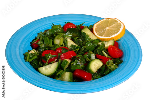 Tomatoes & cucumber fresh salad on a blue plate, on the white background. 