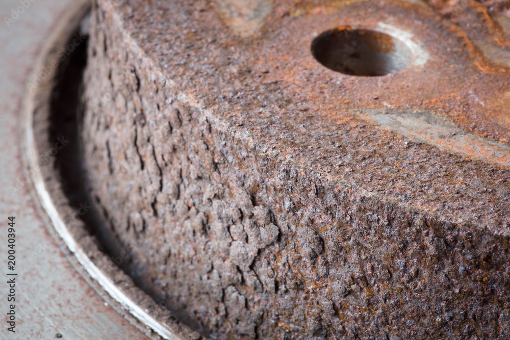 Close-up of an obsolete and rusty disk bracke
