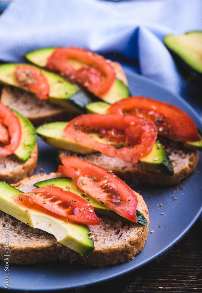 Toast with avocado and tomato slices
