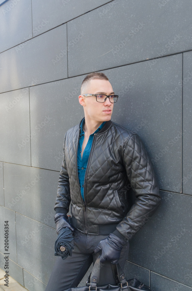 brutal man in a jacket and glasses on the street brutal man in a jacket and glasses on the street