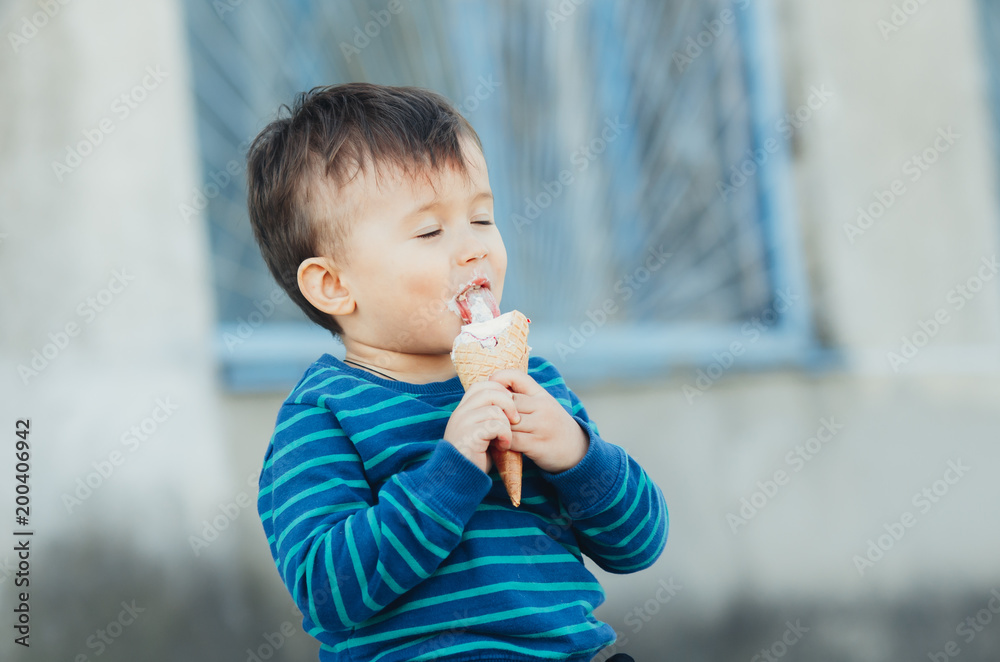 Baby eating ice cream outdoors, in abandoned places, outside the house grunge style Baby eating ice cream outdoors, in abandoned places, outside the house grunge style
