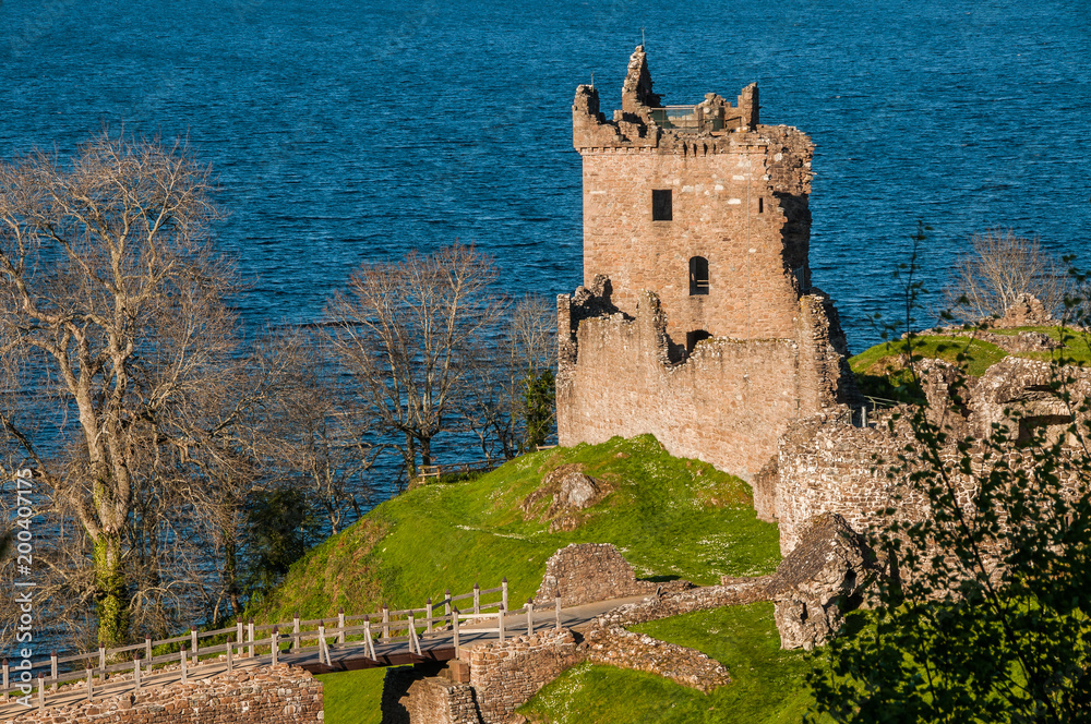 Urquhart Castle sits beside Loch Ness in the Highlands of Scotland overlooking the Urquhart Bay on the Loch.