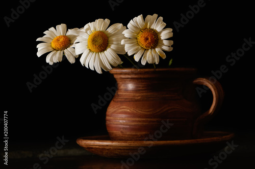 Chamomile in a clay cup