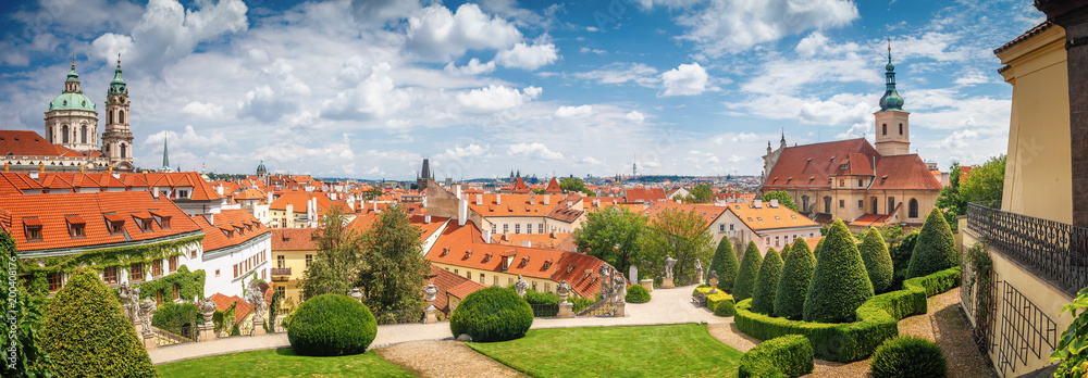 Beautiful summer panorama view on Prague from Vrtba garden (18th century) and st. Nicholas church, Prague