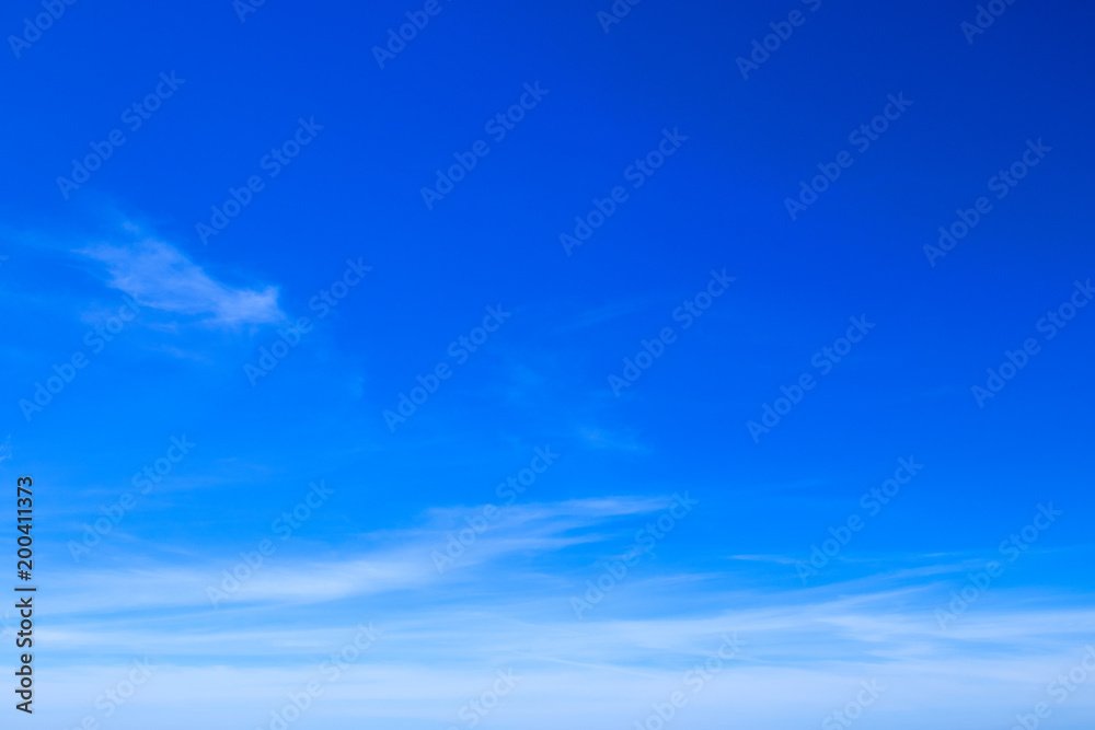 Brilliant blue sky background with sparse clouds in daylight. Brilliant blue sky background with sparse clouds in daylight.