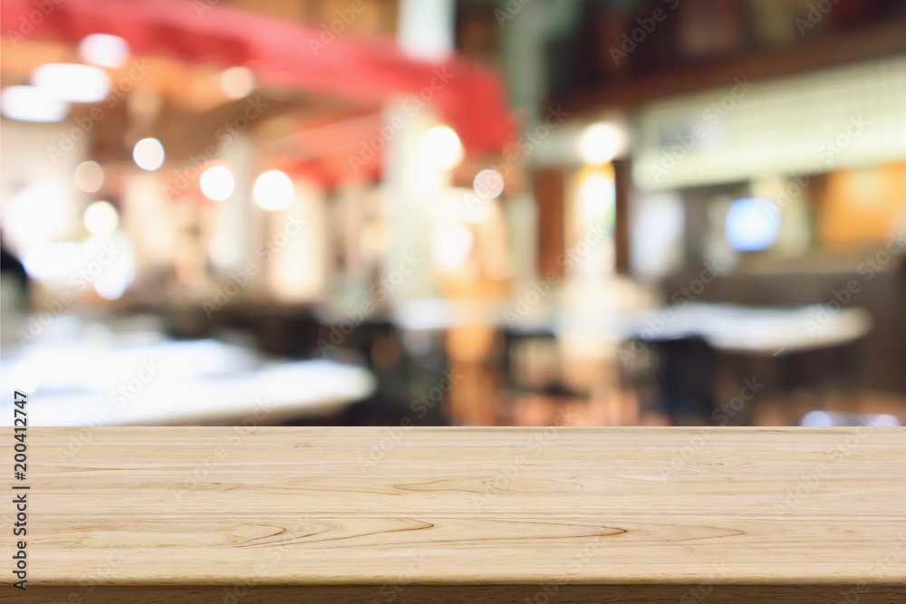 wood table with abstract blurred cafe restaurant with bokeh lights defocused background