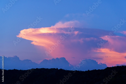 Sunset over jungle. Cloud like a nuclear mushroom. Tropic island.