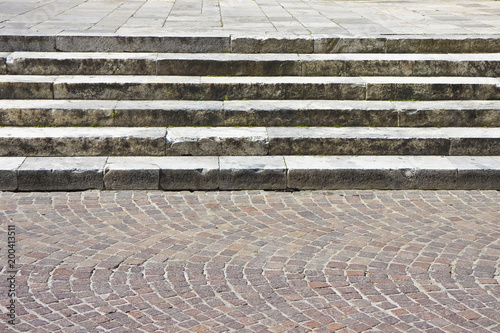 Detail of an old italian stone staircase whit paving stone in porphyry cube shape - image with copy space