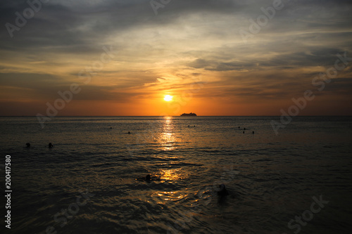 Cruise liner on the horizon against the setting sun