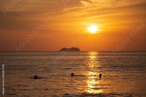 Cruise liner on the horizon against the setting sun