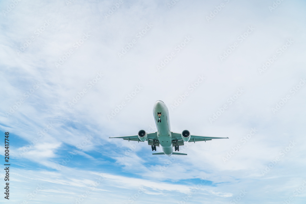 Fototapeta premium Airplane aircraft flying, landing in the good weather at blue cloudy sky
