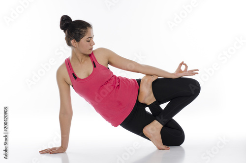  Young woman doing yoga, India © mm