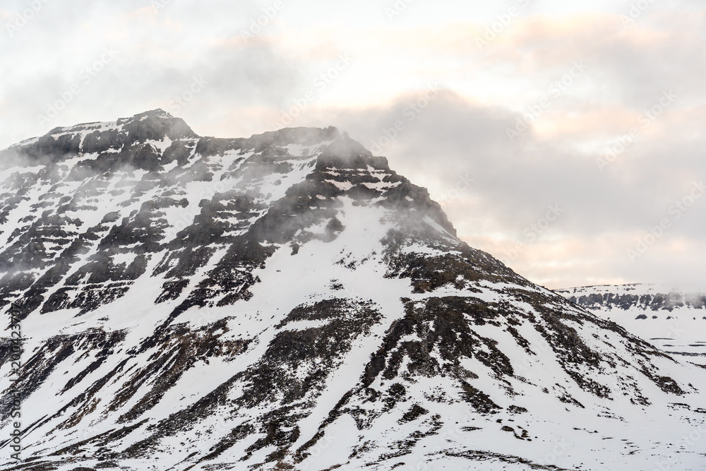 snow covered mountains in the clouds during sunset snow covered mountains in the clouds during sunset