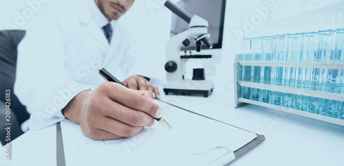 Obraz na plátně scientist makes a note of experiment in the laboratory
