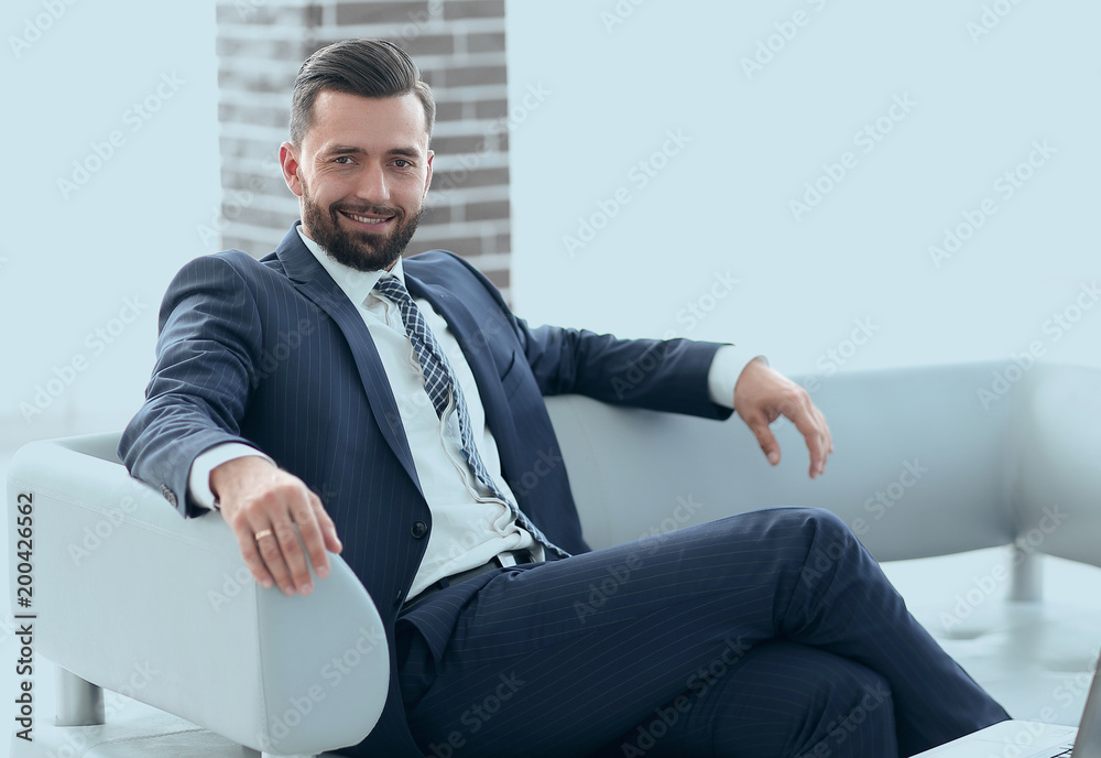 Portrait of a successful businessman sitting in the office lobby Portrait of a successful businessman sitting in the office lobby