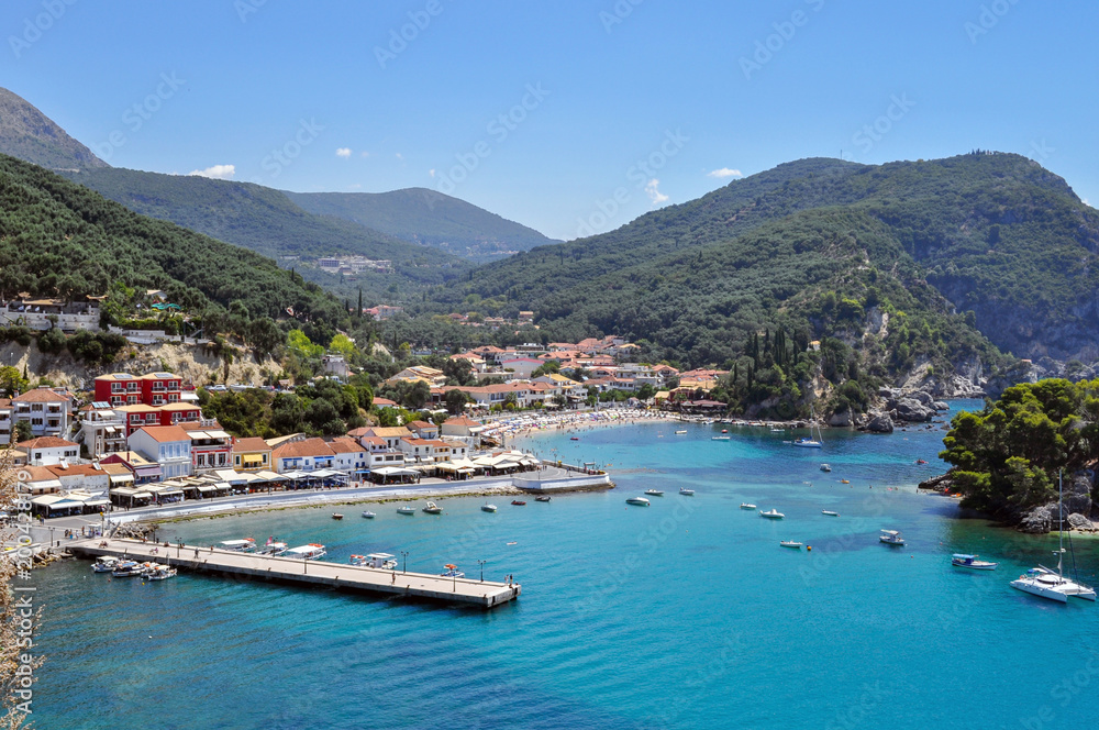 Panoramic view of Parga town in Greece on a sunny day with blue sky. Port, jetty,  Krioneri beach, island of Panagia
