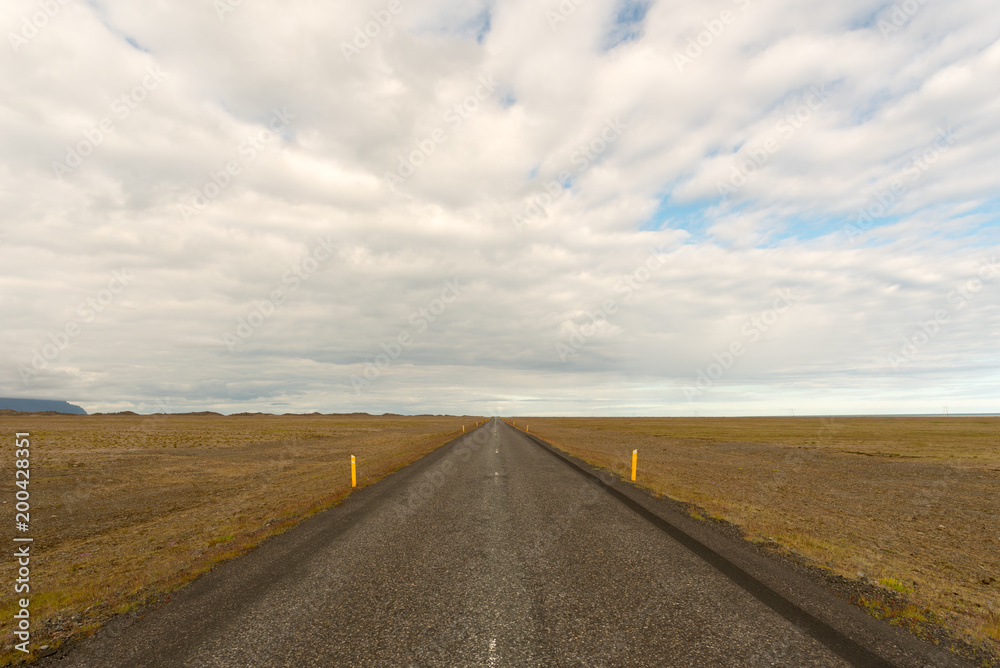 Travel to Iceland. Spectacular Icelandic landscape with road and scenic nature- fjords, fields, clouds. Driving the Ring Road in Southeast Iceland Travel to Iceland. Spectacular Icelandic landscape with road and scenic nature- fjords, fields, clouds. Driving the Ring Road in Southeast Iceland