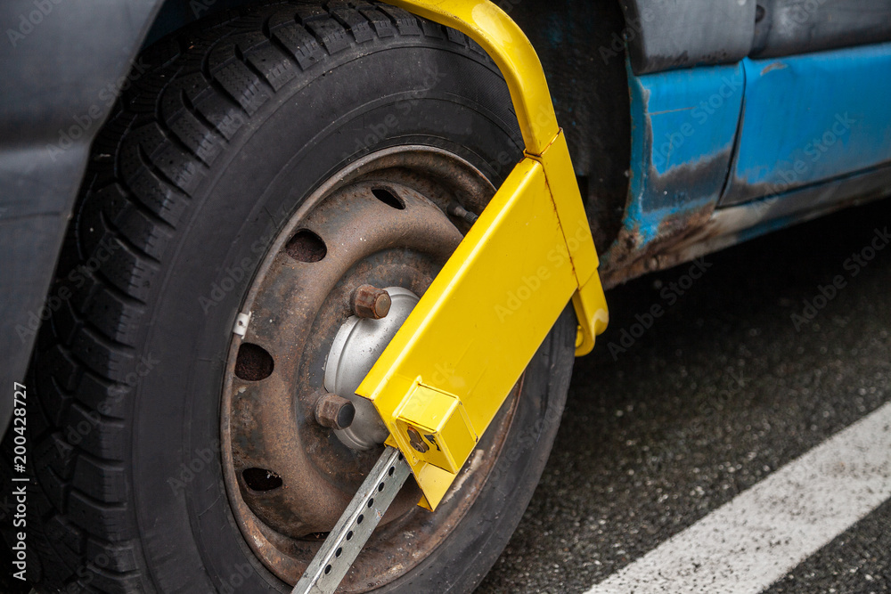 yellow wheel lock device on a blue van in germany