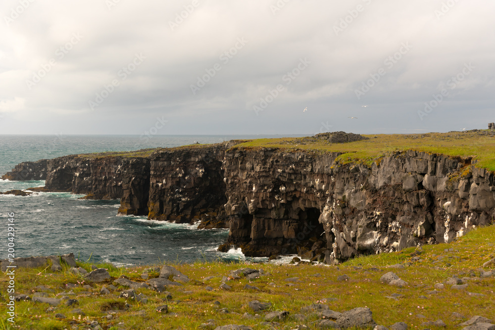 Naklejka premium Southern Peninsula-Travel to Iceland. Spectacular Icelandic landscape with road and scenic nature- fjords, fields, clouds. Driving the Ring Road in Southeast Iceland