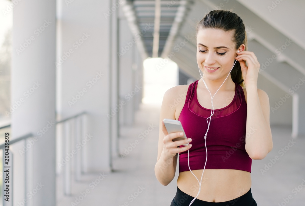 Portrait of an active young girl browsing music for her workout