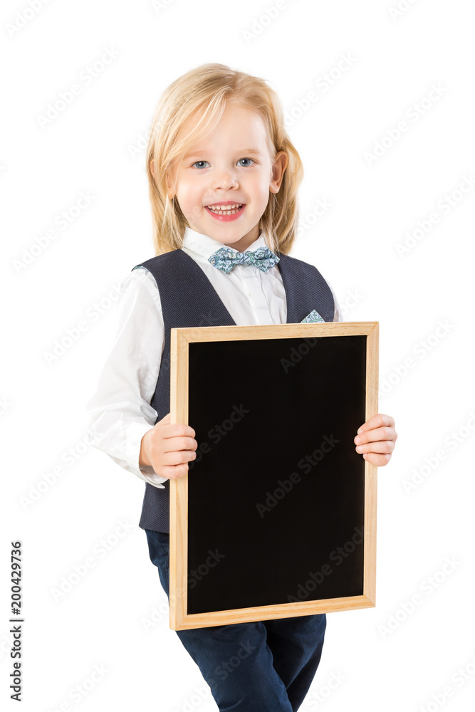 Smart boy in suit with long blond hair is smiling and holding blank blackboard isolated at white background. Smart boy in suit with long blond hair is smiling and holding blank blackboard isolated at white background.