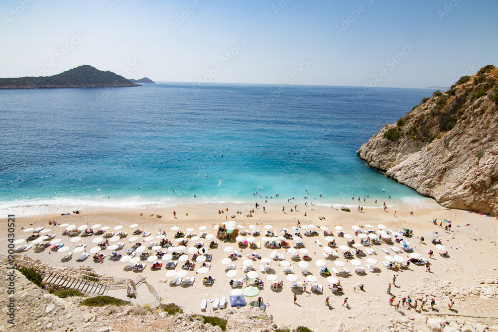 Tourists sunbathing and swimming on the Kaputas Beach, Kas, Antalya Turkey - obrazy, fototapety, plakaty 