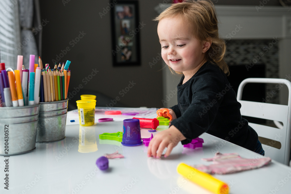 Girl playing with craft supplies at home Girl playing with craft supplies at home