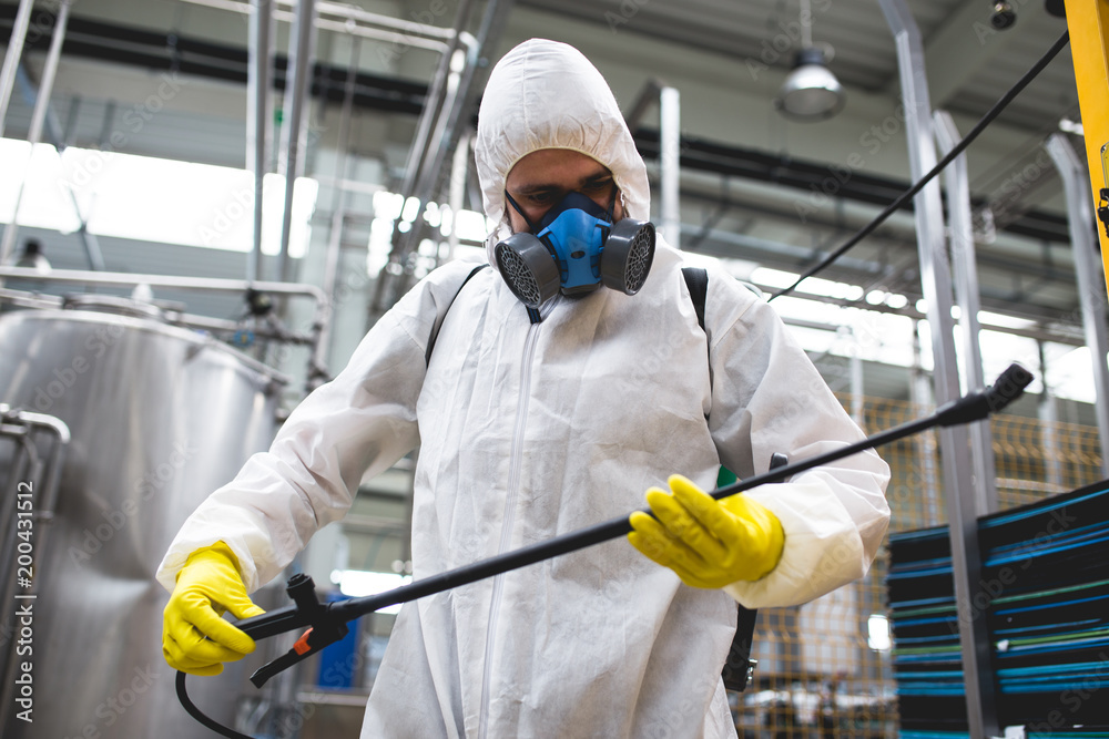 Pest Control Worker Hand Holding Sprayer For Spraying Pesticides in production or manufacturing factory Pest Control Worker Hand Holding Sprayer For Spraying Pesticides in production or manufacturing factory