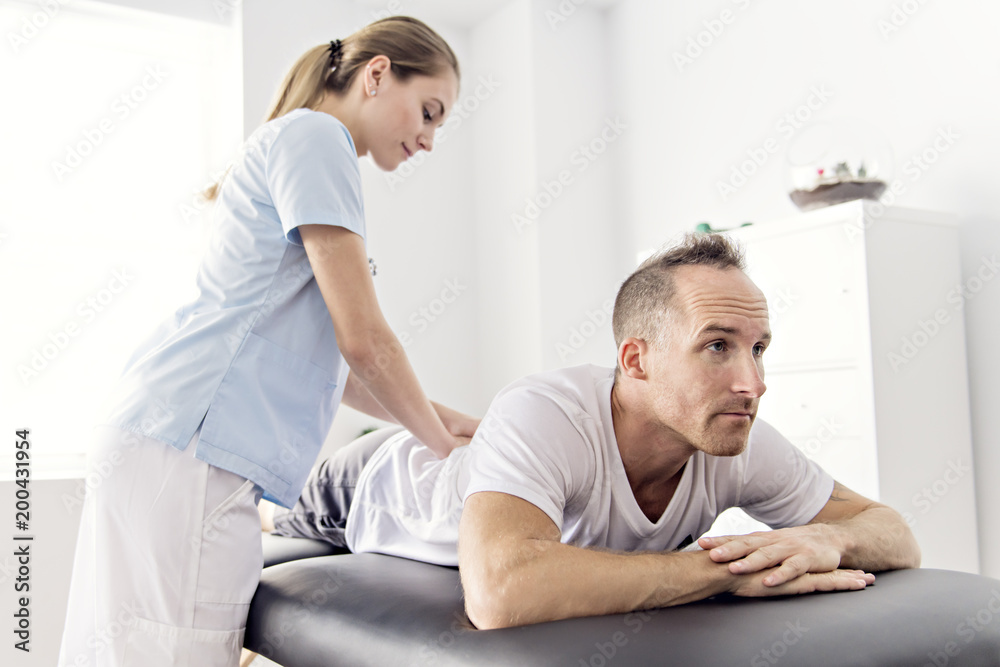 Obraz premium Patient at the physiotherapy doing physical exercises with his therapist