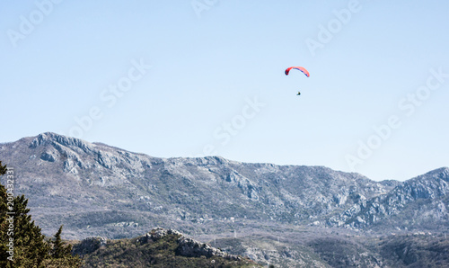 red paraplane in blue sky