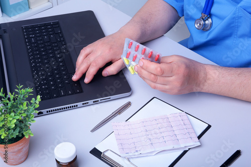 Doctor hand showing drug boxes at Office Desktop. Health care, Medical and Pharmacy Concept.