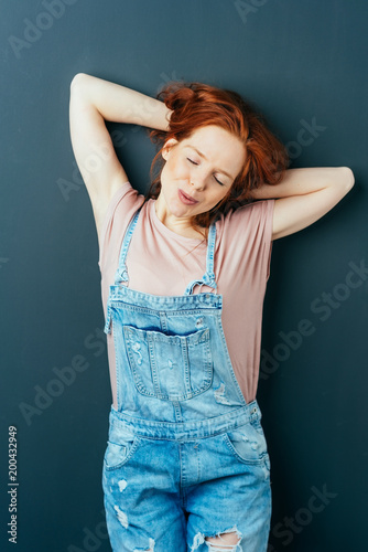 Relaxed cute young woman in designer dungarees © contrastwerkstatt