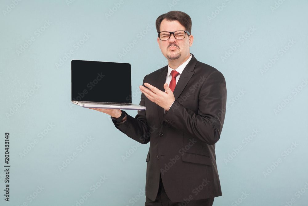 Business, gadgets,technologies. Businessman holding broken favorite lap top, bad day Business, gadgets,technologies. Businessman holding broken favorite lap top, bad day