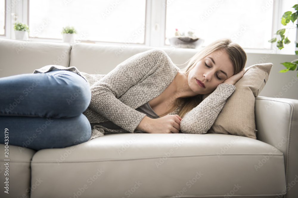 Beautiful young woman is sleeping and seeing sweet dreams.