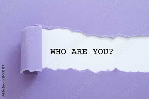 Who are you question written under torn paper.