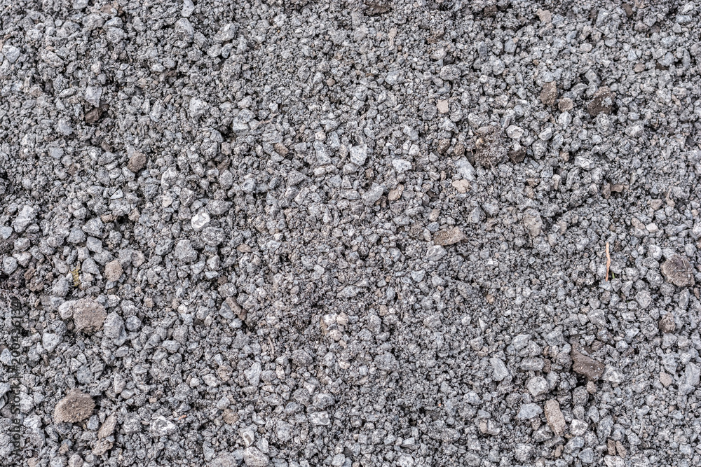 Grauer Schotter als Baumaterial für Straßenbau und Wegebau als Textur Grauer Schotter als Baumaterial für Straßenbau und Wegebau als Textur