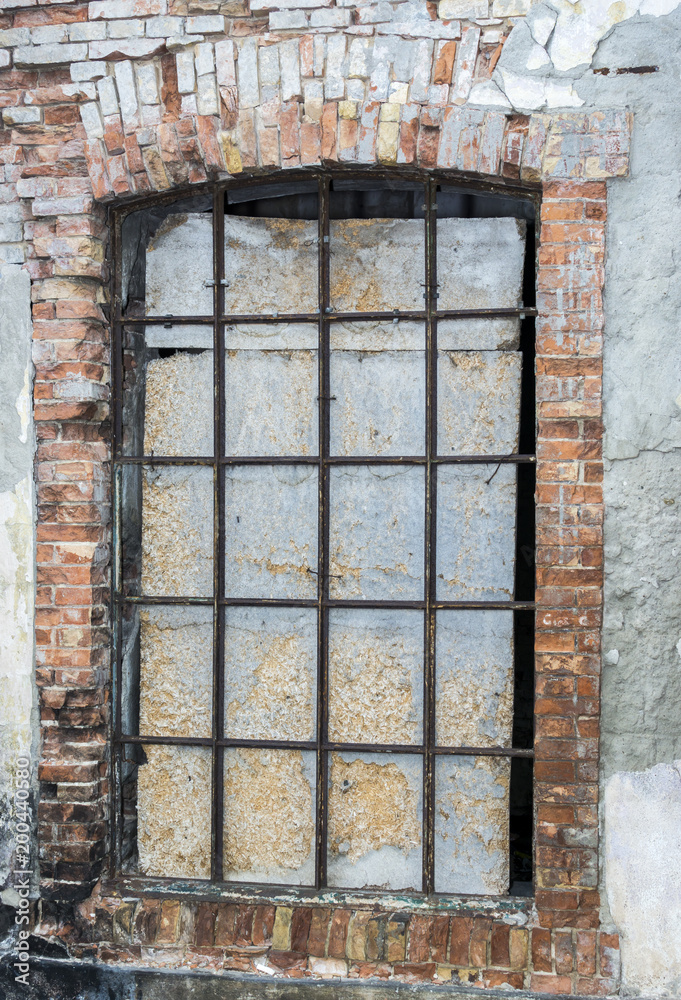 Old window in an old brick wall, Window with grid