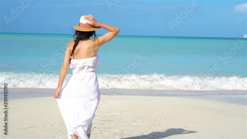 Wallpaper Mural Young beautiful woman on white sand tropical beach. Torontodigital.ca