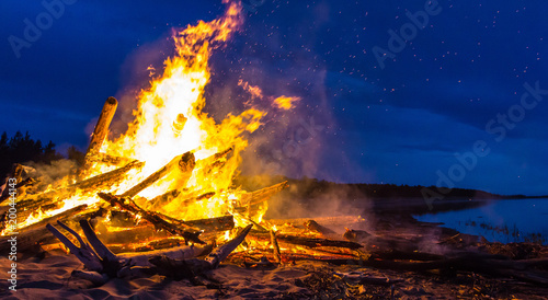 Big bonfire on the shore at night