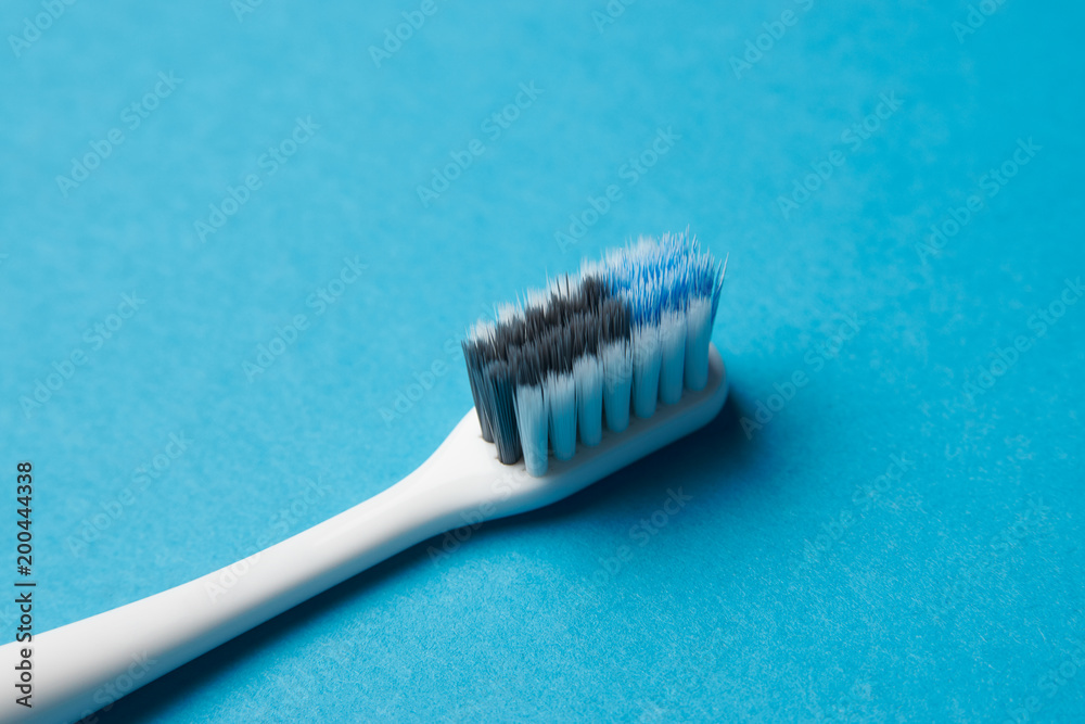 Toothbrush on blue background, close-up, copy space. Dental equipment, oral health care concept. Toothbrush on blue background, close-up, copy space. Dental equipment, oral health care concept.