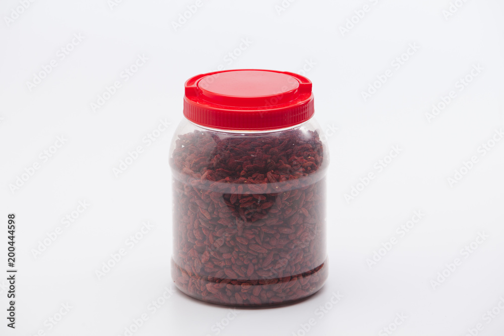 Dried red goji berries in plastic bottle isolated Dried red goji berries in plastic bottle isolated