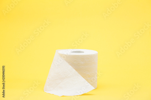 White toilet roll paper on yellow background
