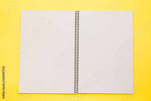  Open note book with blank pages on yellow