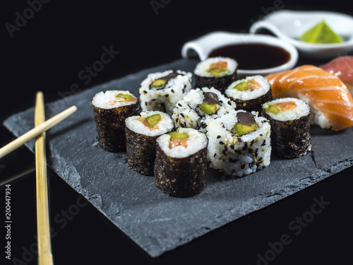 Sushi Set on Slate with Sushi Rolls and Wasabi on Black Background
